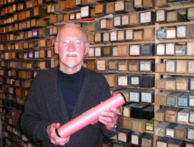 Denis Condon in his roll room, holding a Welte-Mignon reproducing piano roll (2006)